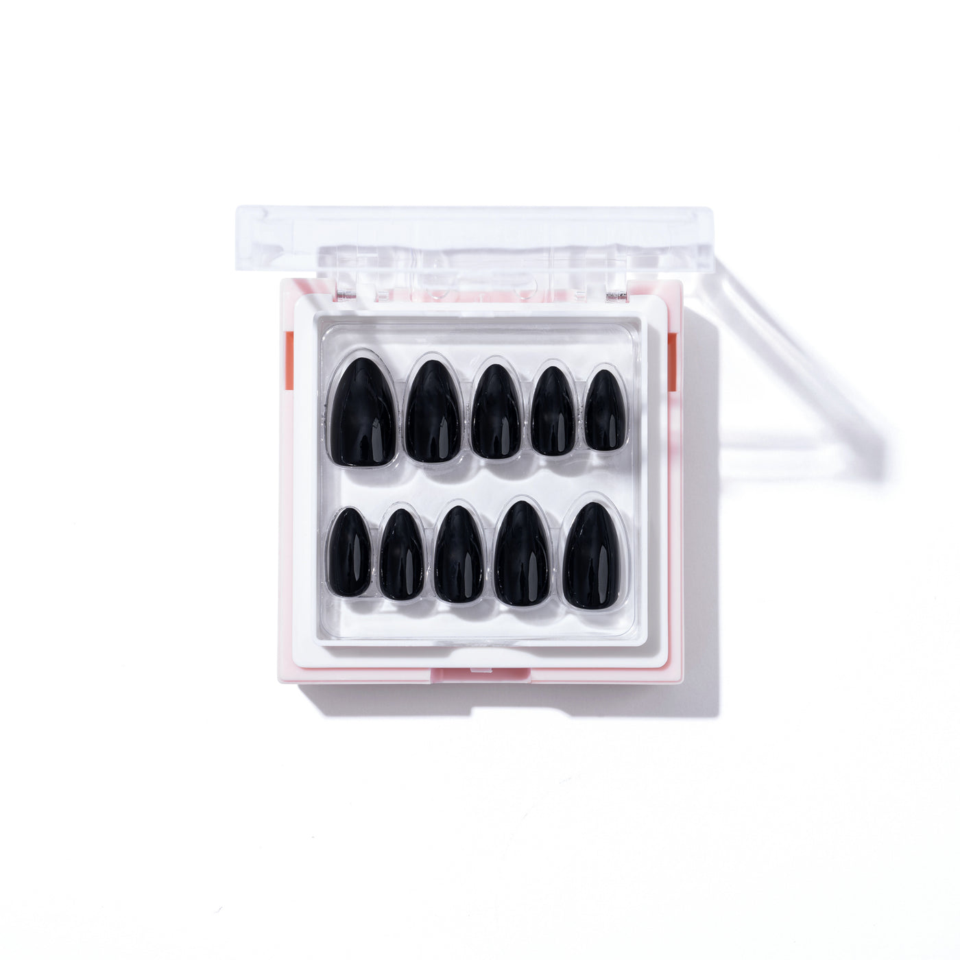 An open box of "After Hours" black customizable nails from Glowie By Her is placed on a white surface, showcasing a neat arrangement of ten salon-quality nails inside a clear plastic case, with shadows softly falling to the right.
